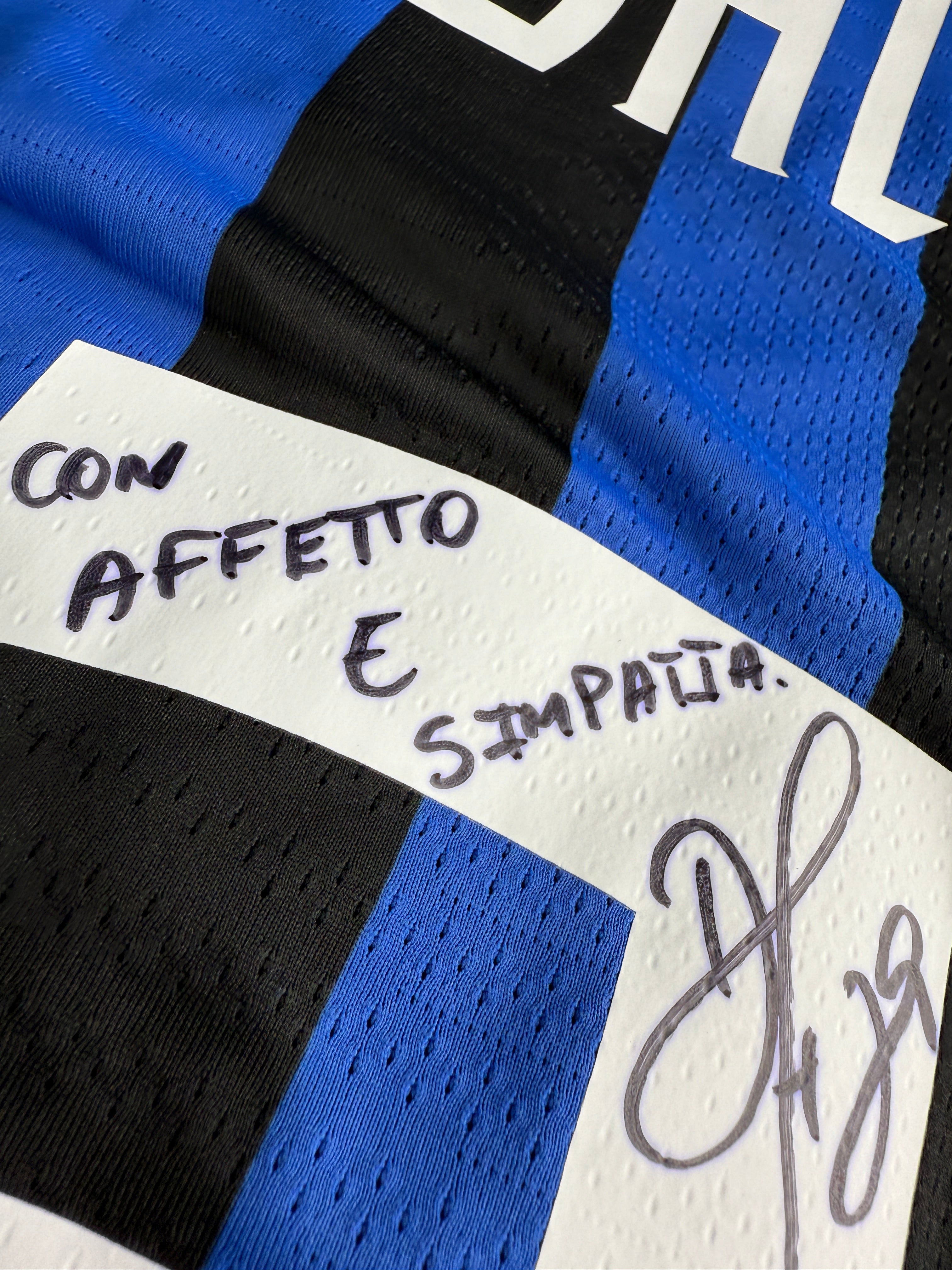 Close-up of a sports jersey with text and signature