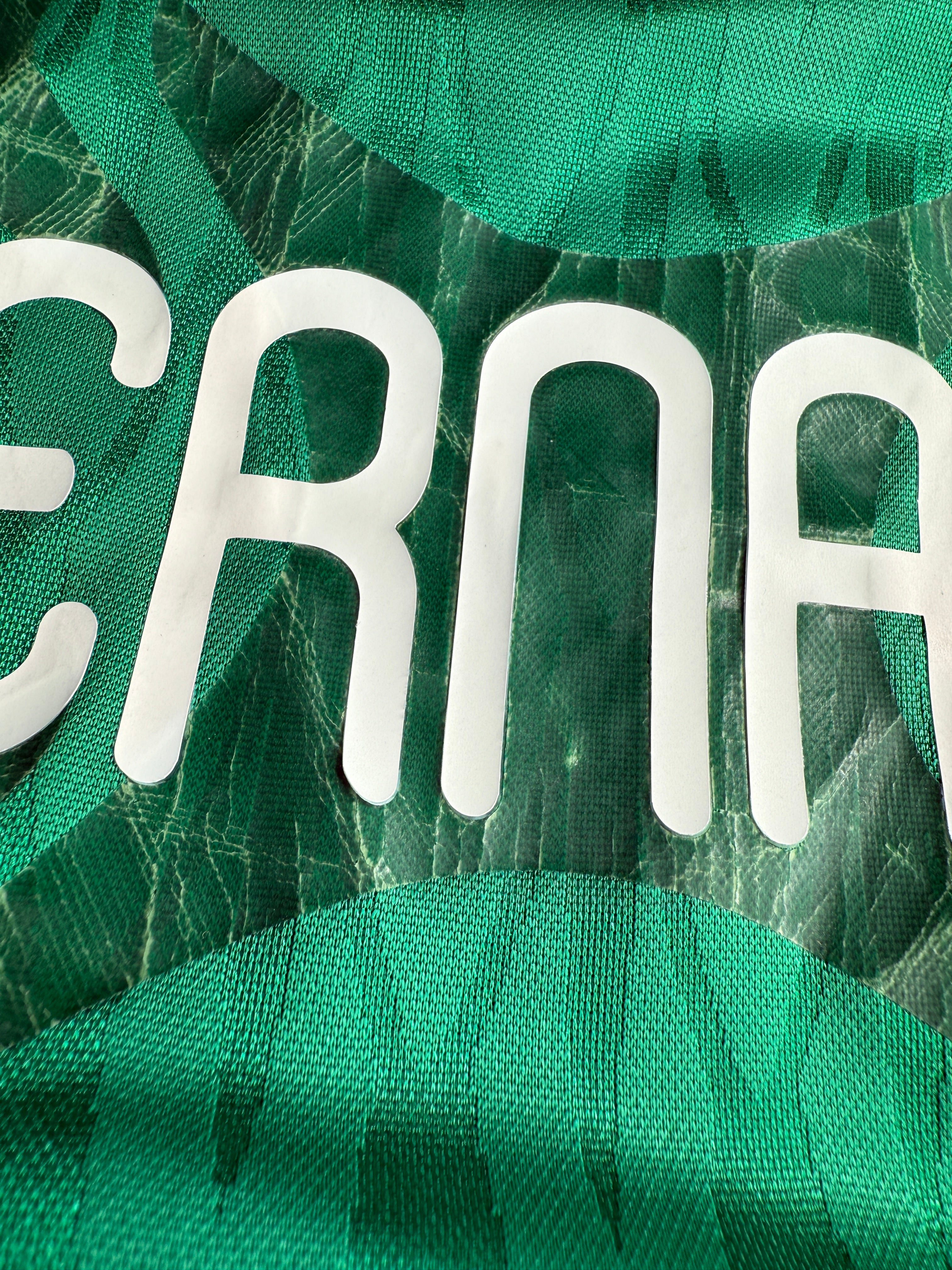 Close-up of green fabric with white lettering.