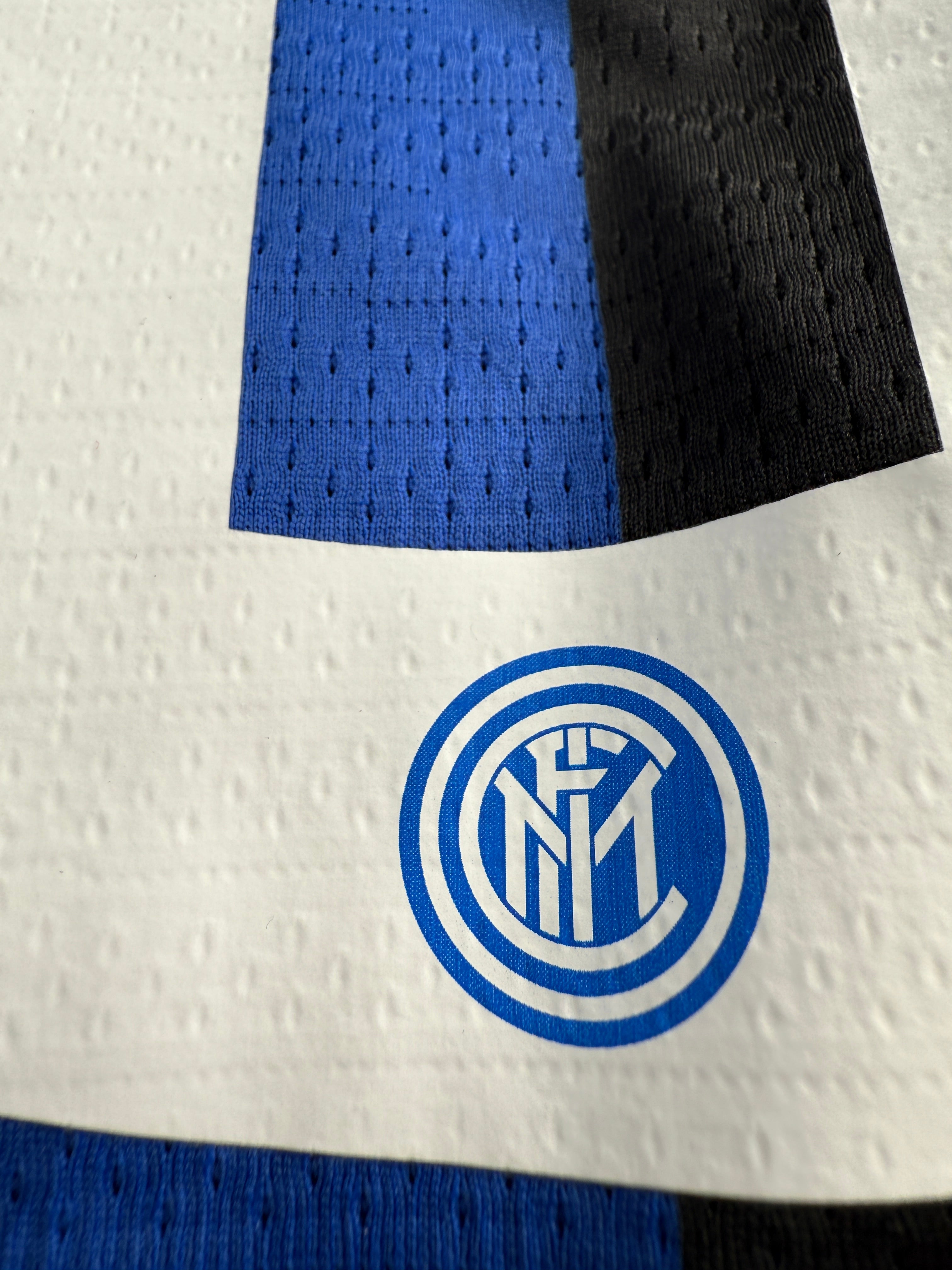 Close-up of a textured surface with a blue and black logo.