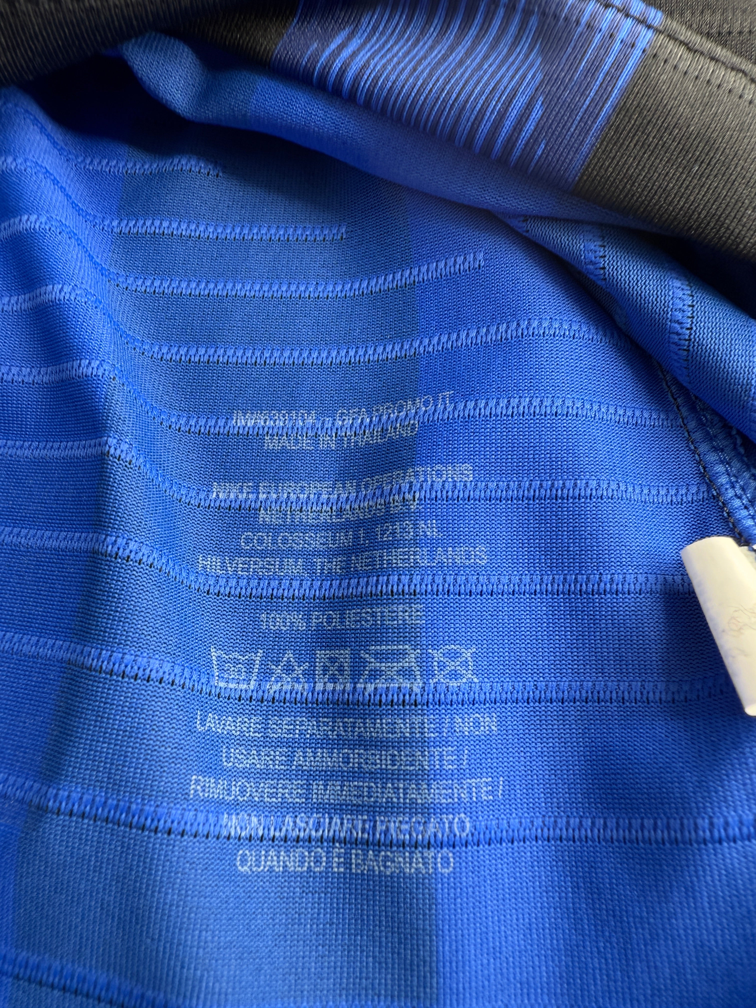Close-up of blue fabric with text and labels.