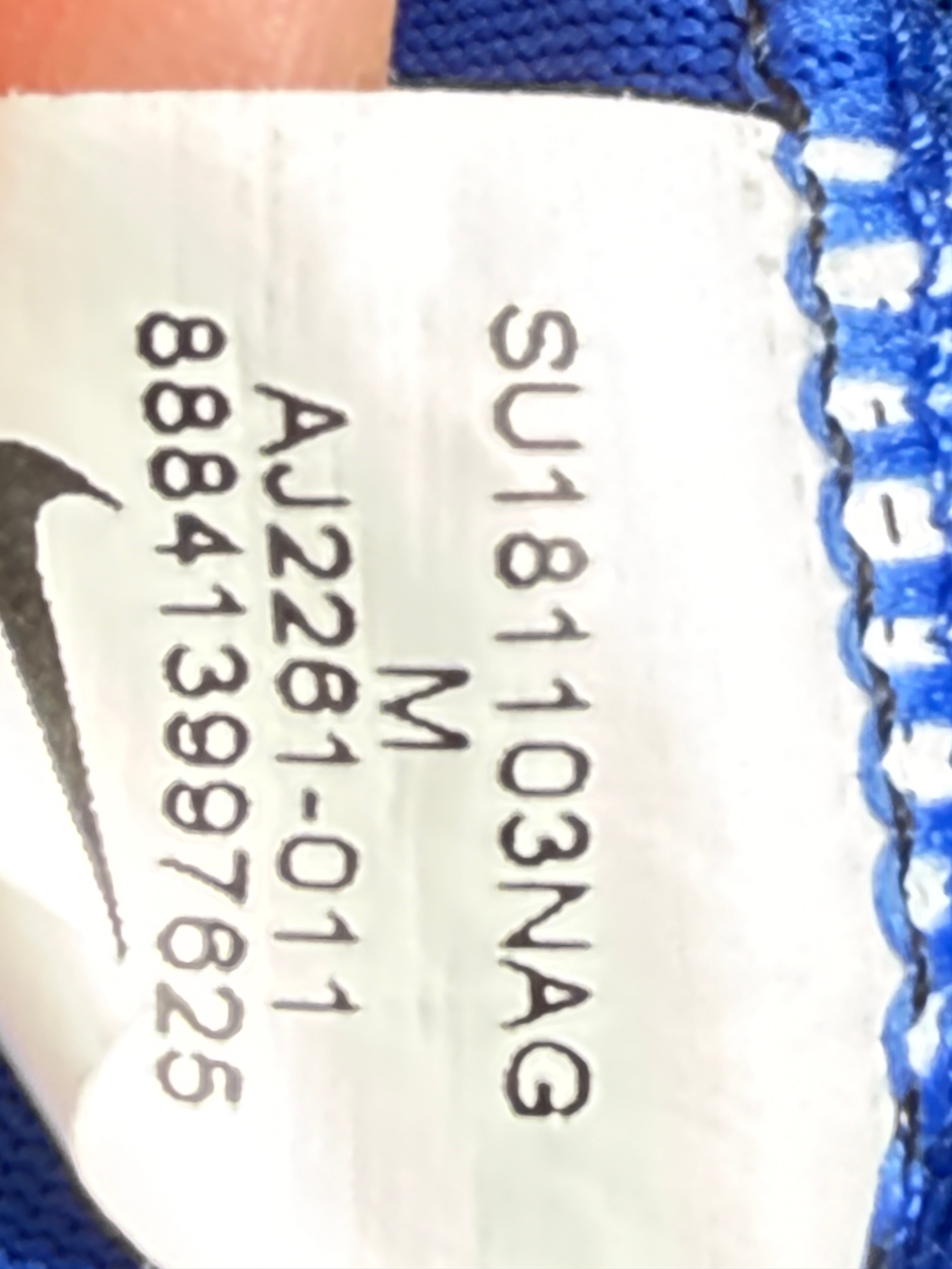 Close-up of a product tag with text and a logo.