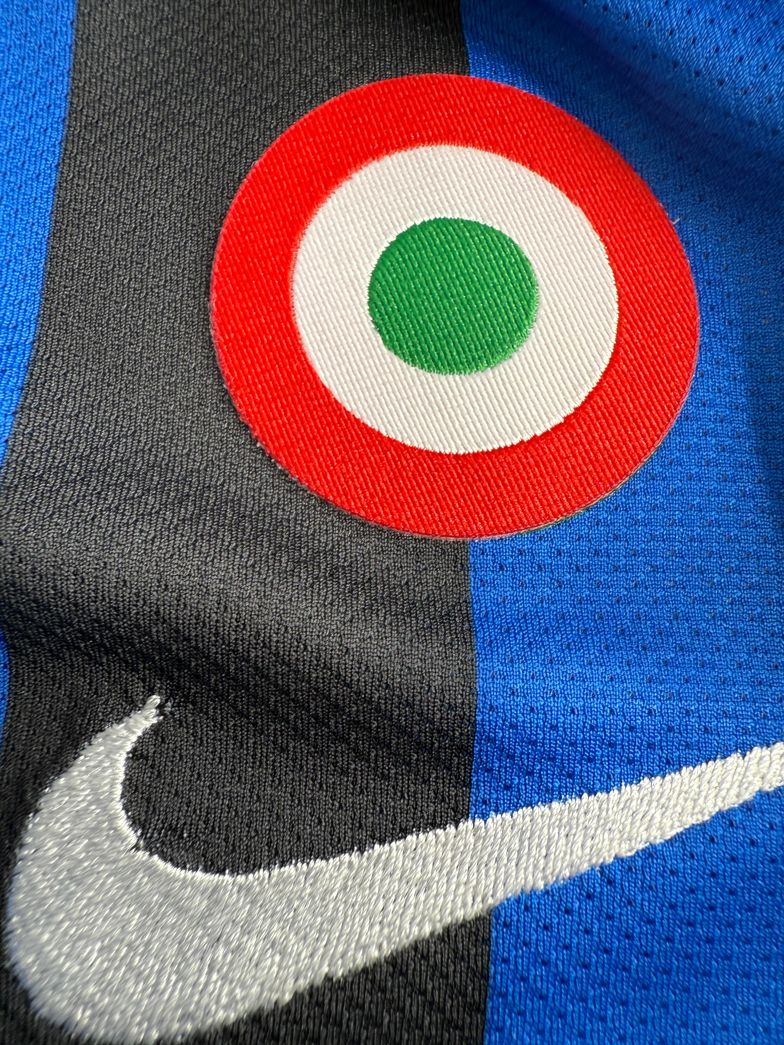 Close-up of a logo with red, white, and blue colors on a sports jersey.