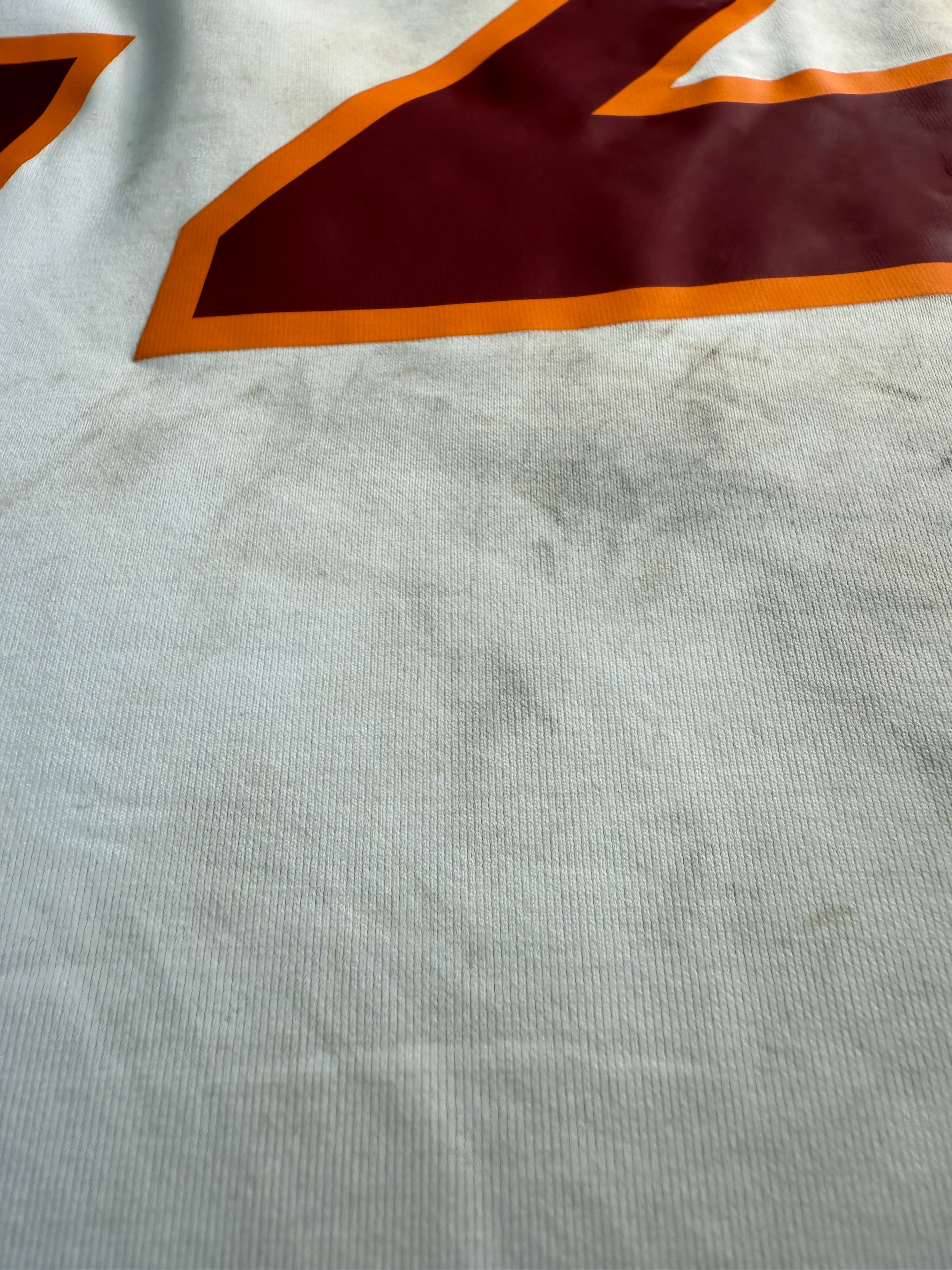 Close-up of fabric with red and orange design on white background