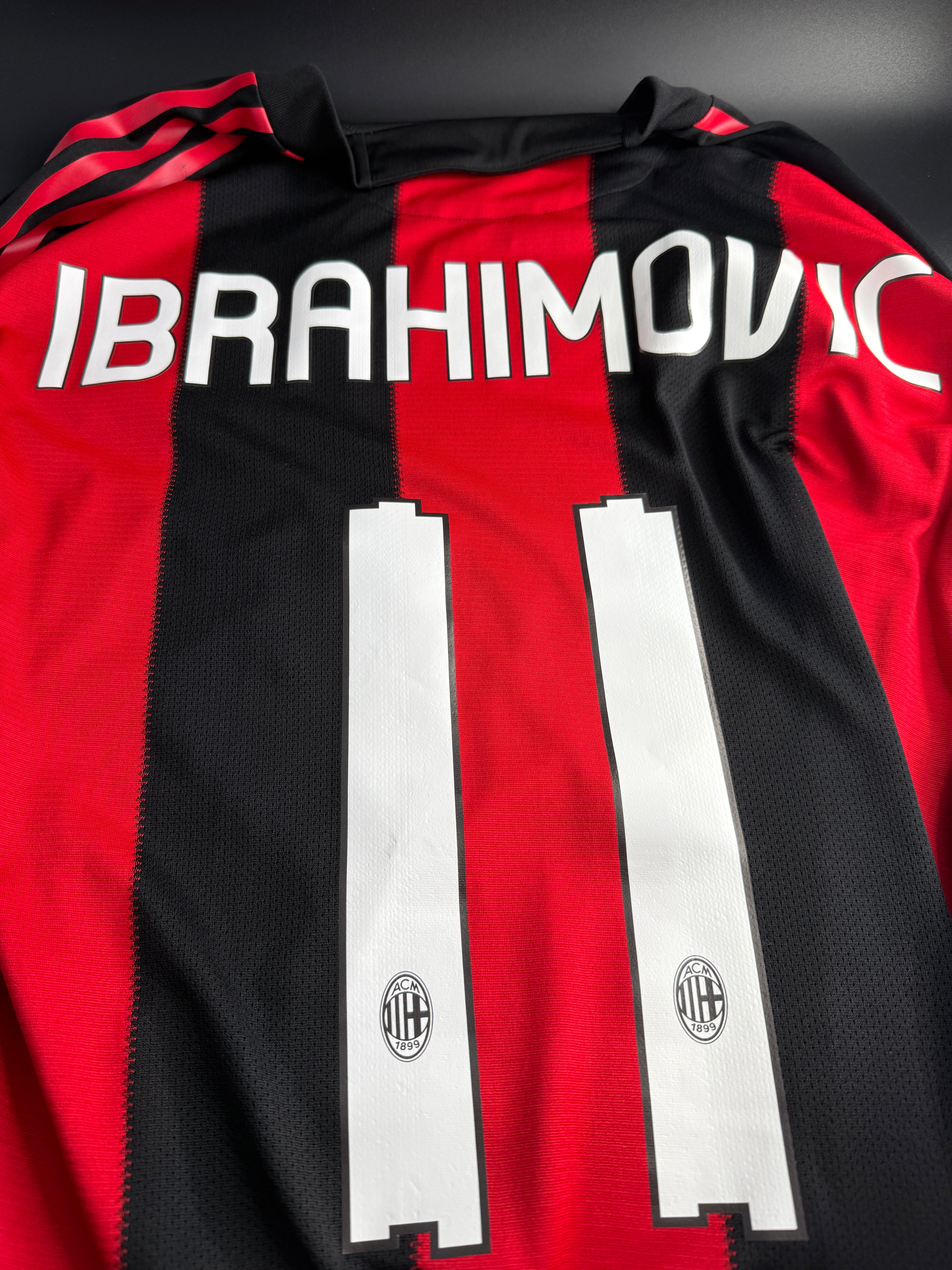 Close-up of a red and black sports jersey with branding and text.
