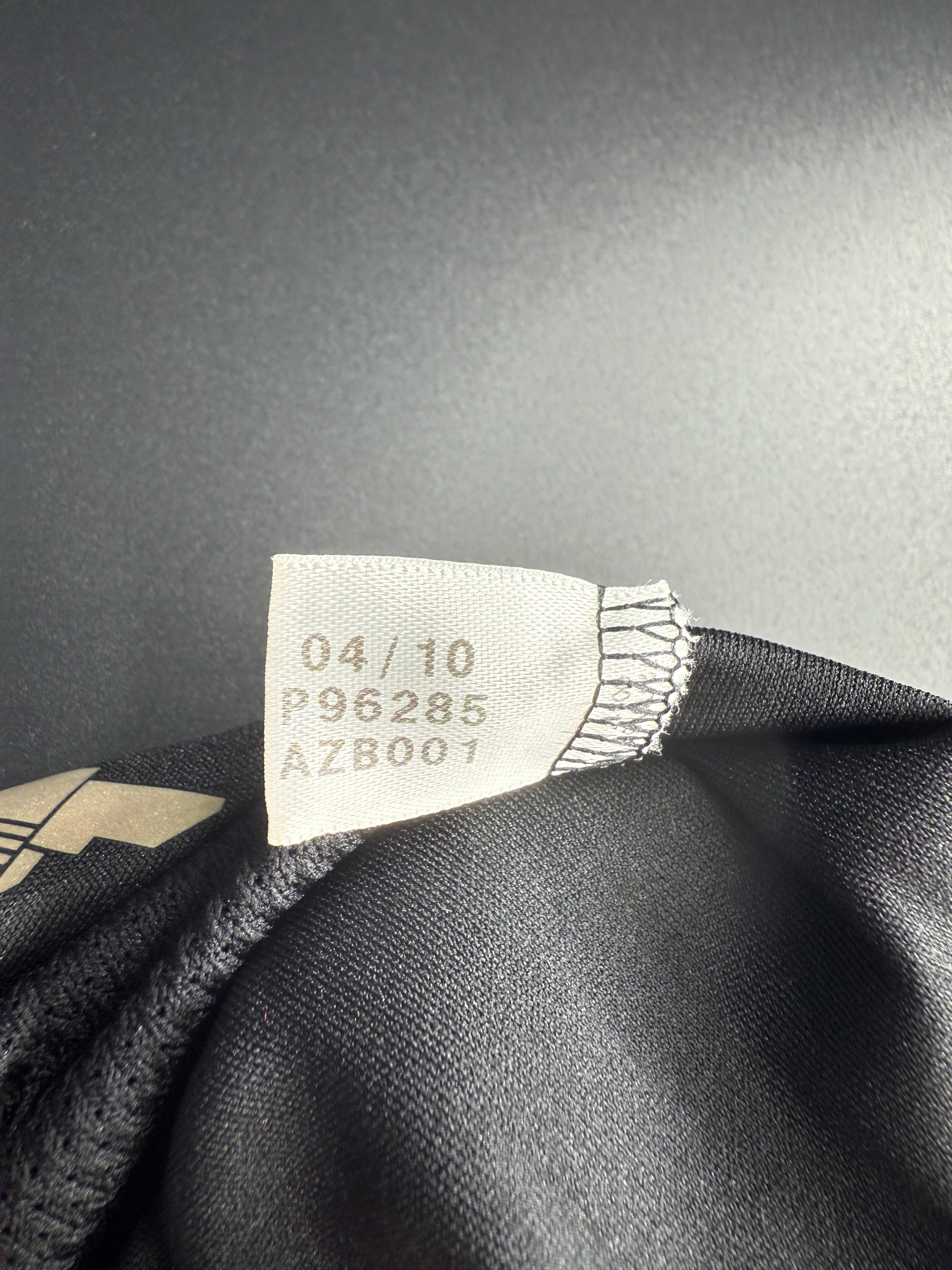 Close-up of a fabric tag with text and numbers.