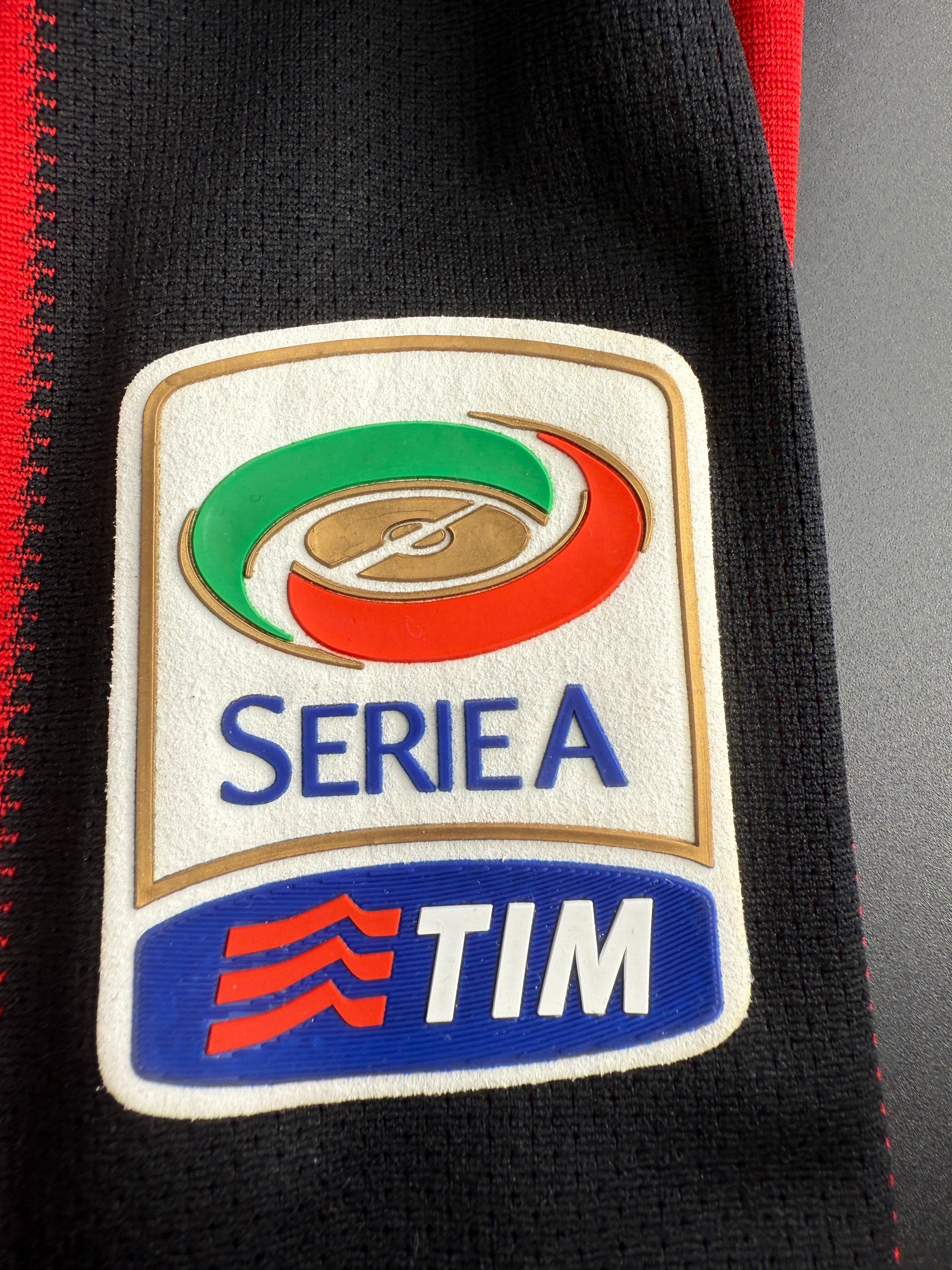 Close-up of a sports jersey patch with 'Serie A' and 'TIM' logos.